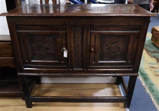 A carved oak cabinet W.129cm